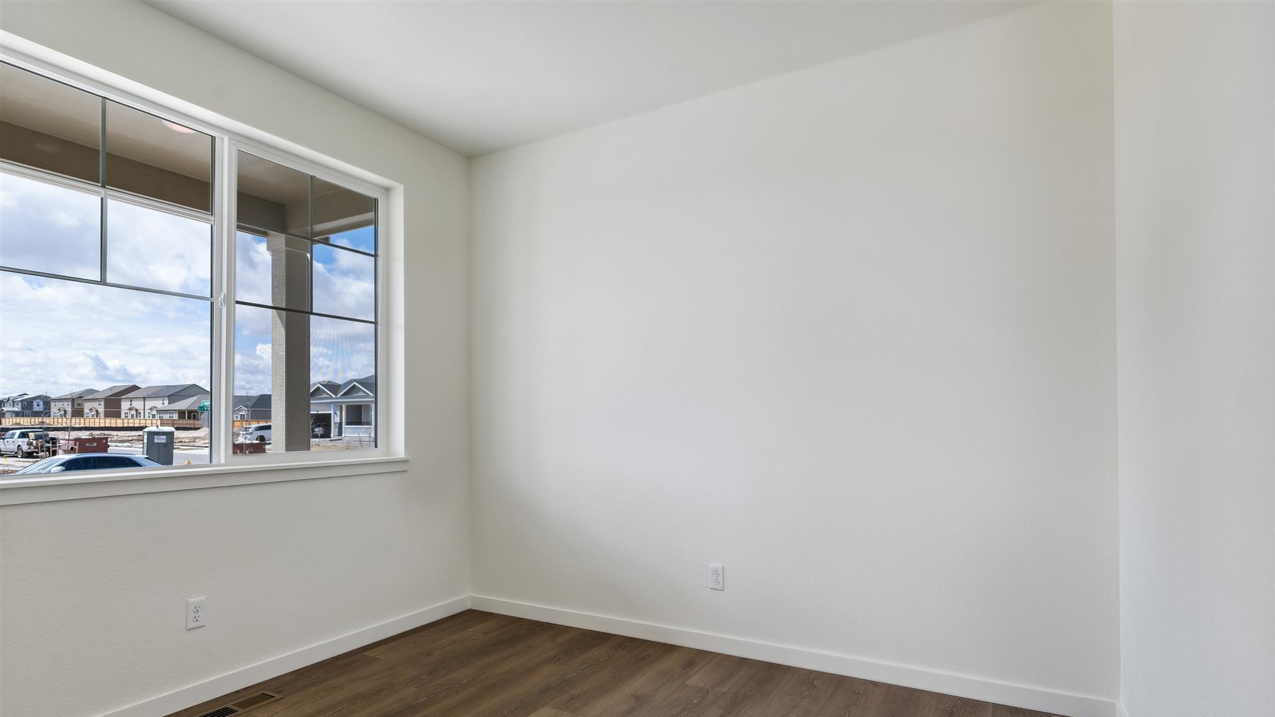 Open study room near entryway and foyer with large window for ample lighting