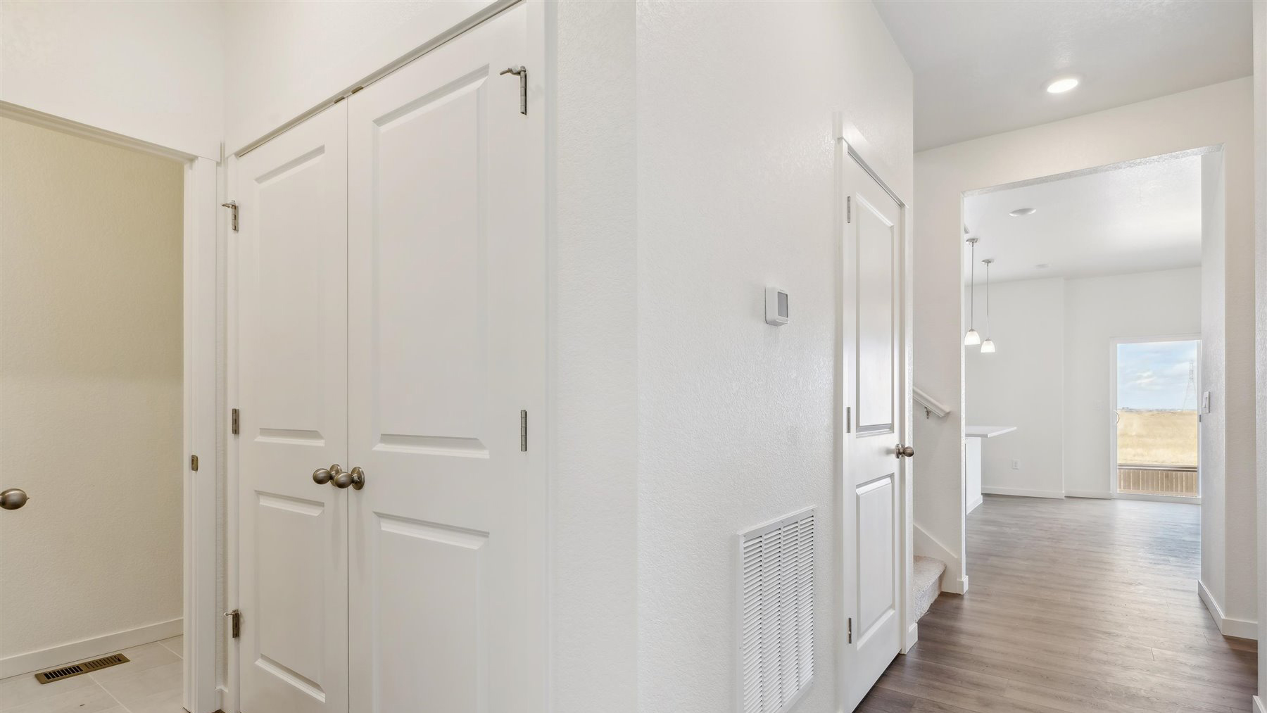 View of powder and mechanical rooms, storage closet near stairwell, and opening to main living area
