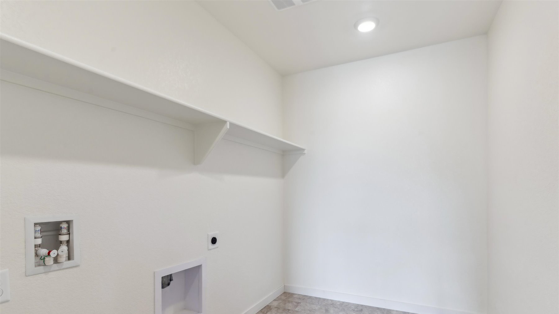 Centrally located second floor laundry room with full size washer/dryer hookups and optional built-in shelving