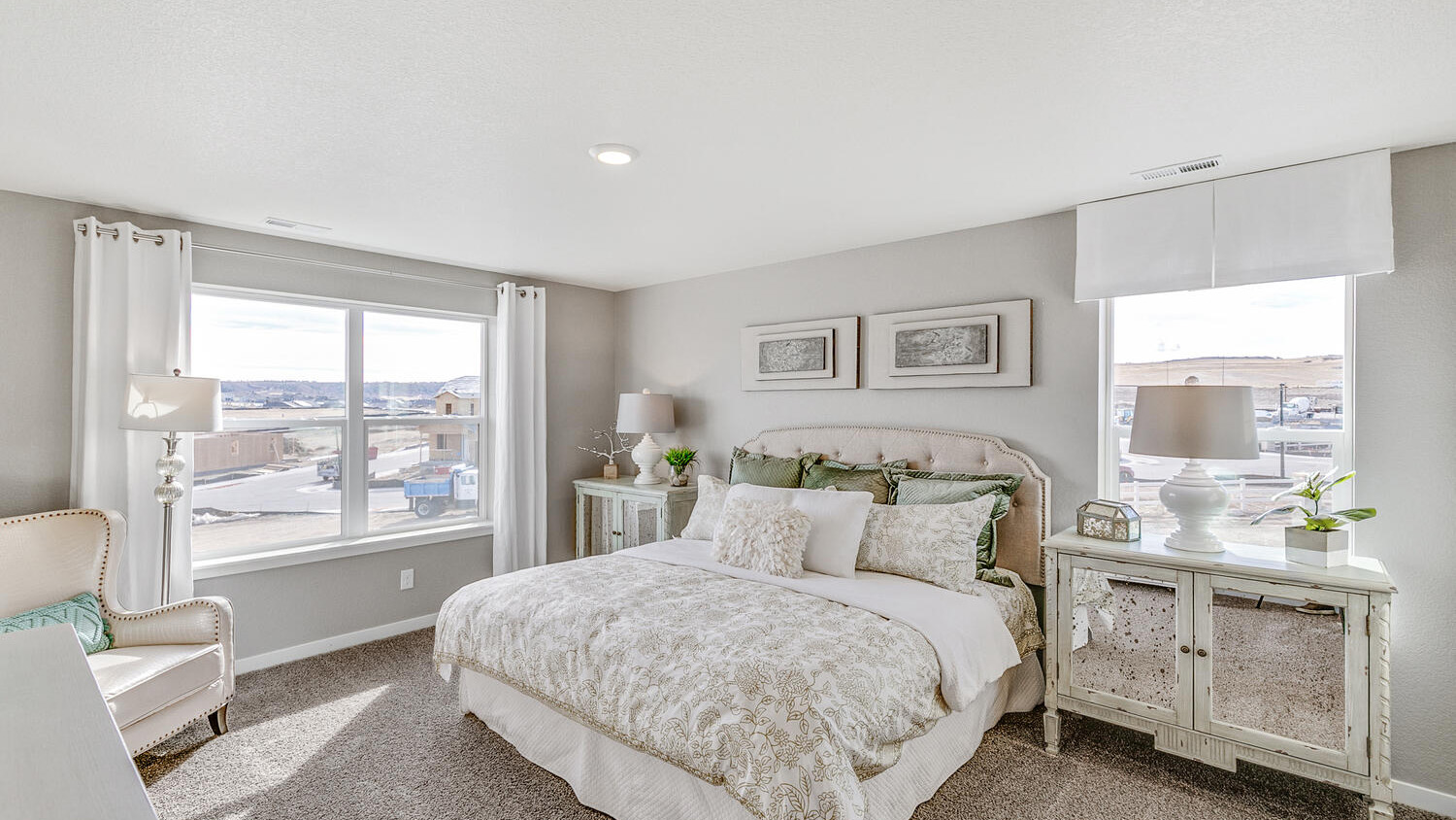 Spacious primary bedroom with large windows in new Henley floor plan