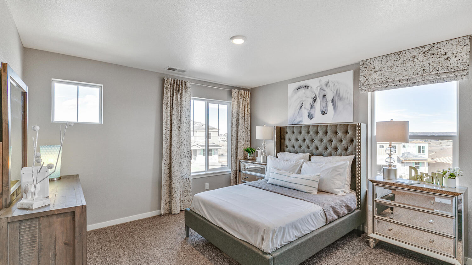 Secondary bedroom with large windows in new home at Settler's Crossing community
