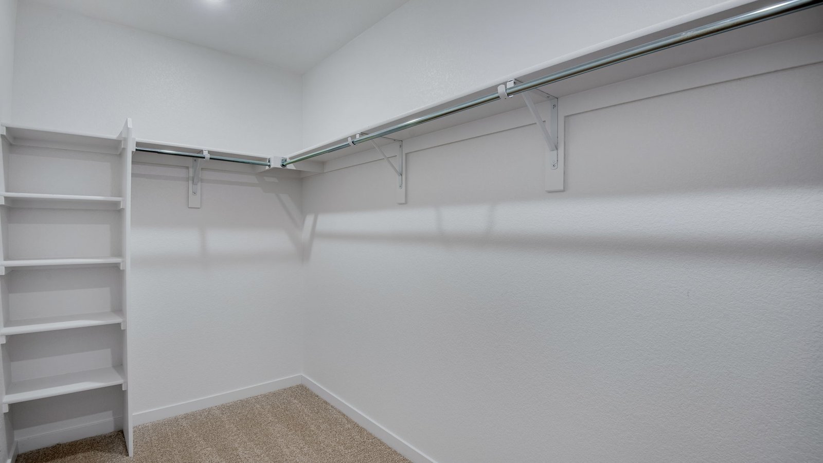 Walk in closet in primary bedroom