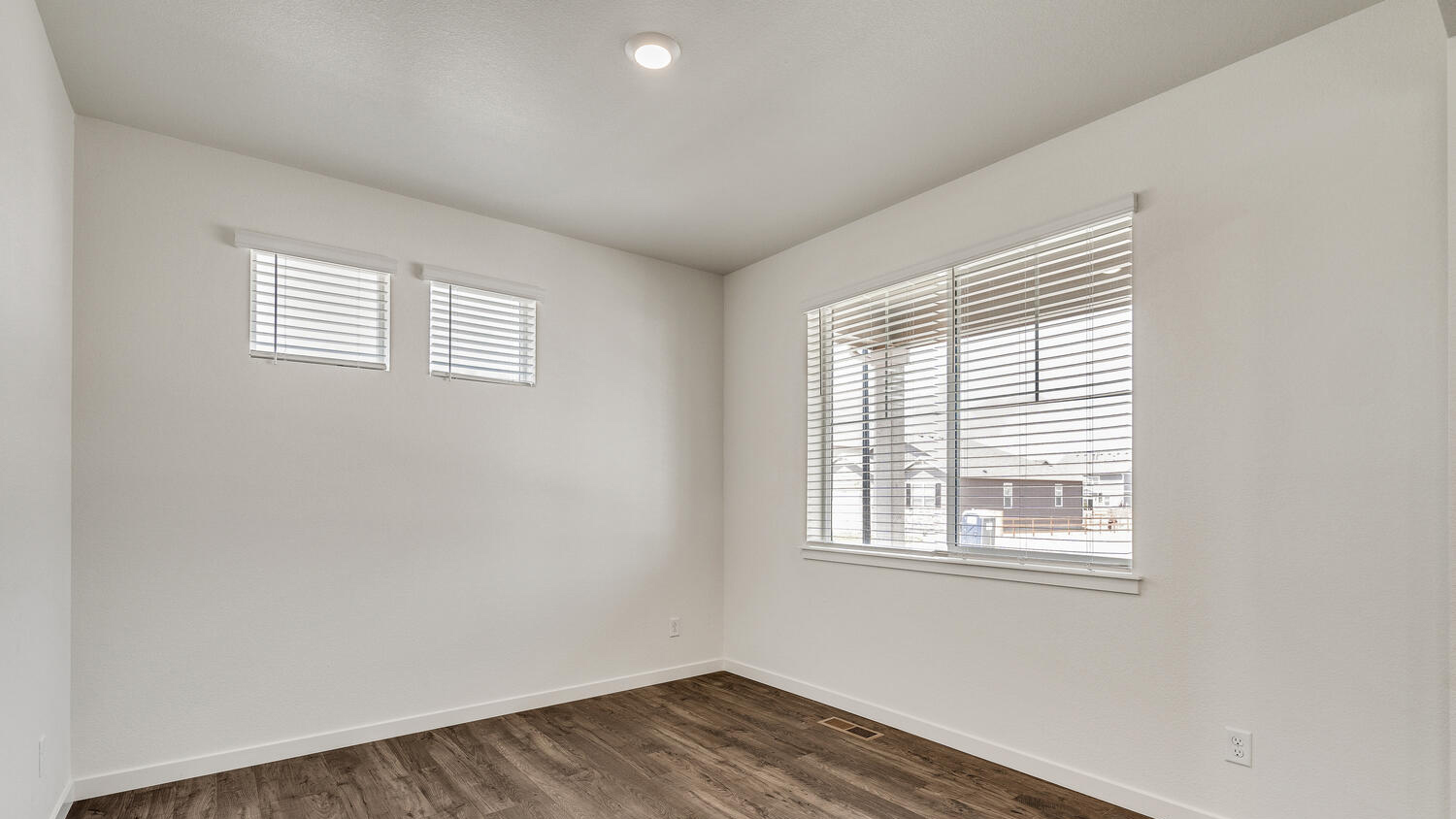 Spacious and open study room near entry with three windows for ample natural lighting
