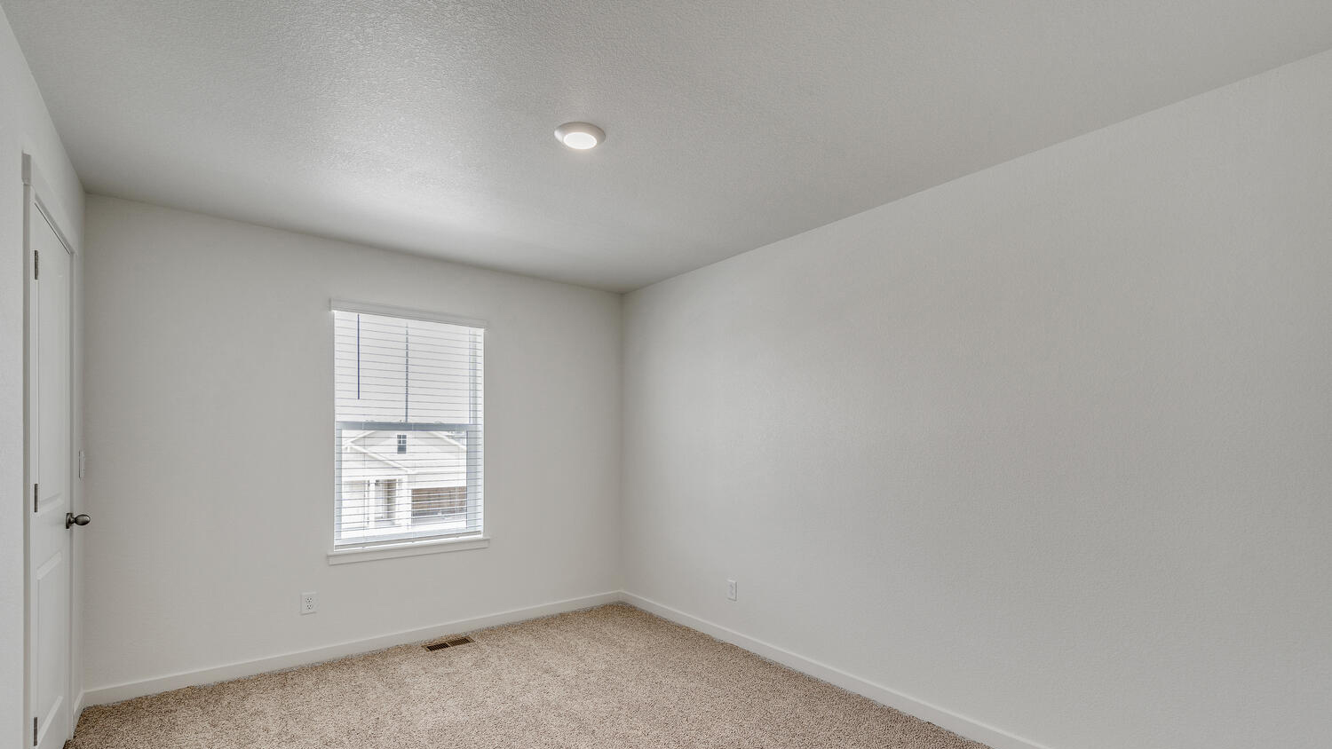 Additional bedroom located next to upper floor living space with walk-in closet and plush carpeting