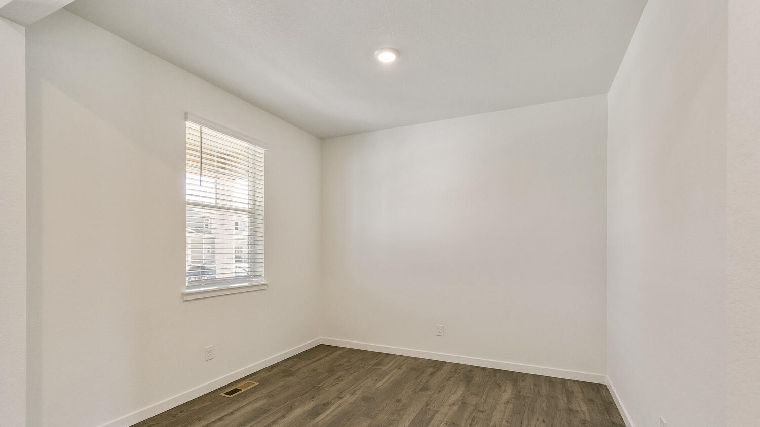 Spacious open study area near front entry featuring ample lighting from front window and energy efficient LED fixtures