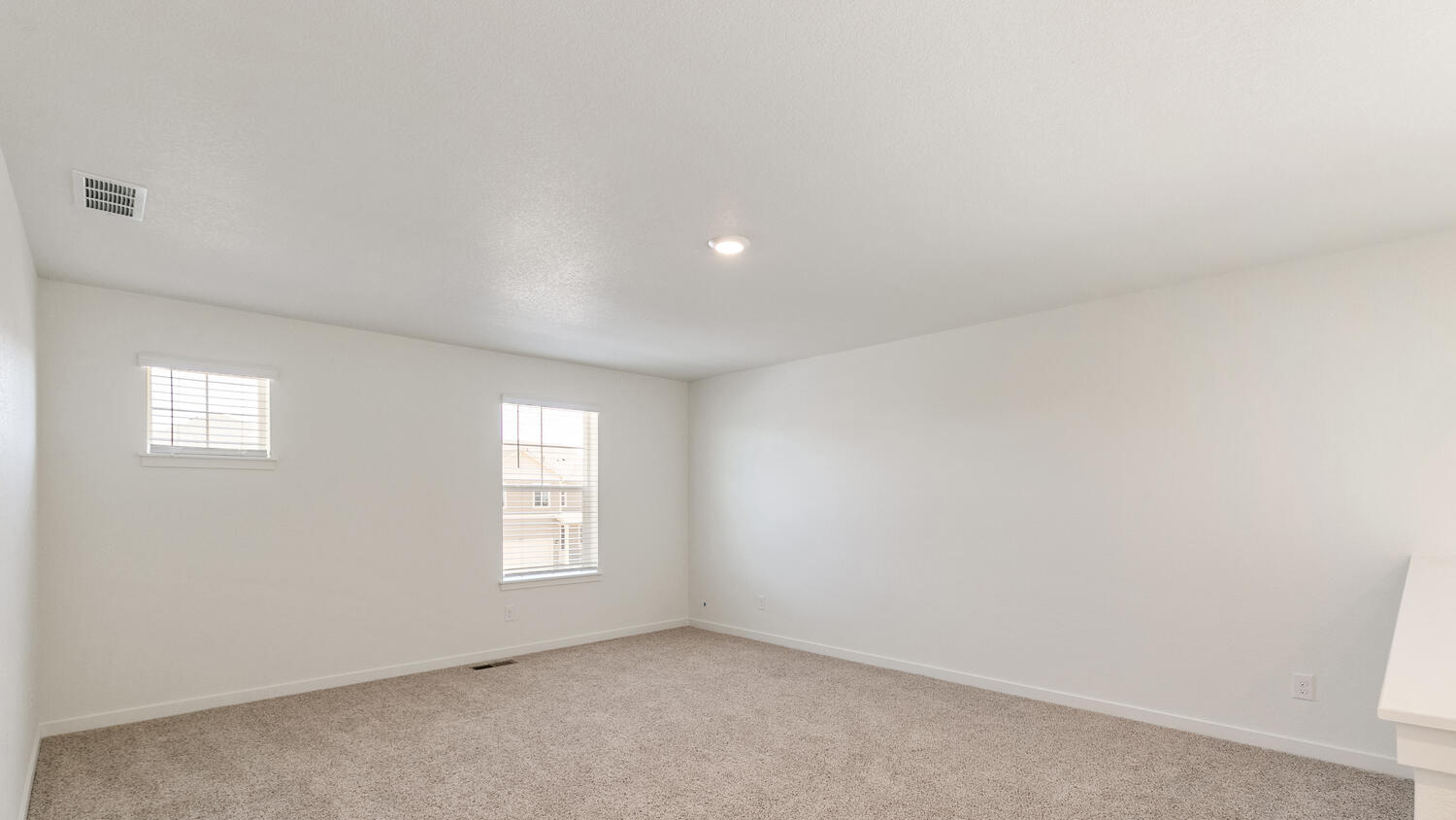Alternate image of upstairs living area featuring plush carpeting, and ample lighting from LED light fixtures and windows