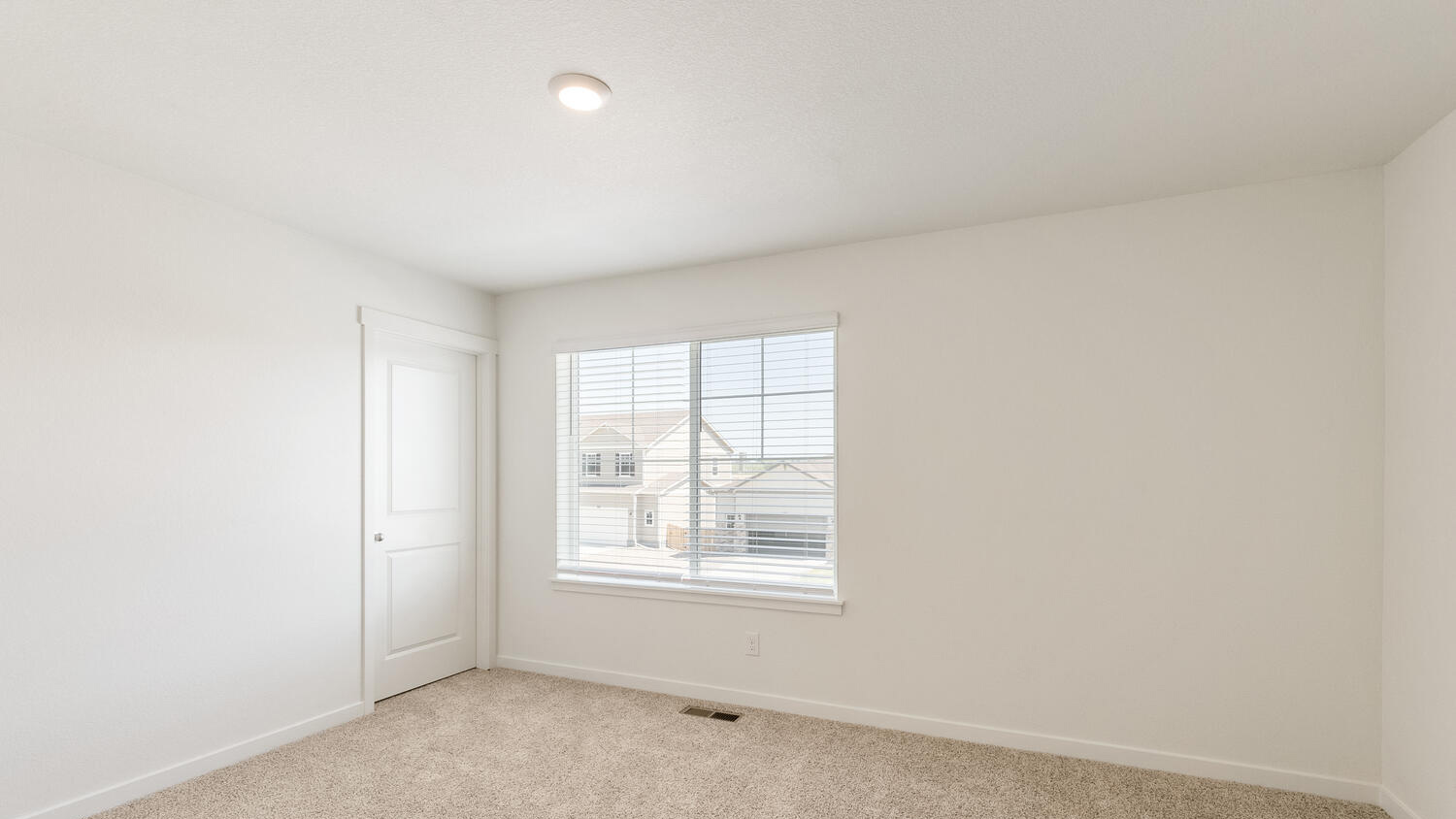 Additional upstairs bedroom with large window for ample natural light and walk-in closet