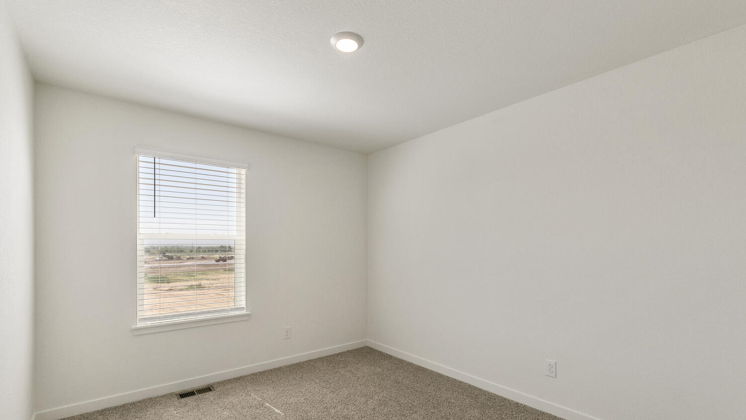 Another bedroom with walk-in closet near secondary bath and primary bedroom suite