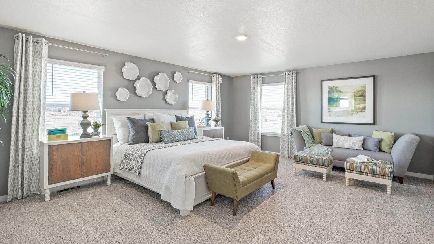 Spacious primary bedroom with large windows in Commerce City, Colorado new home