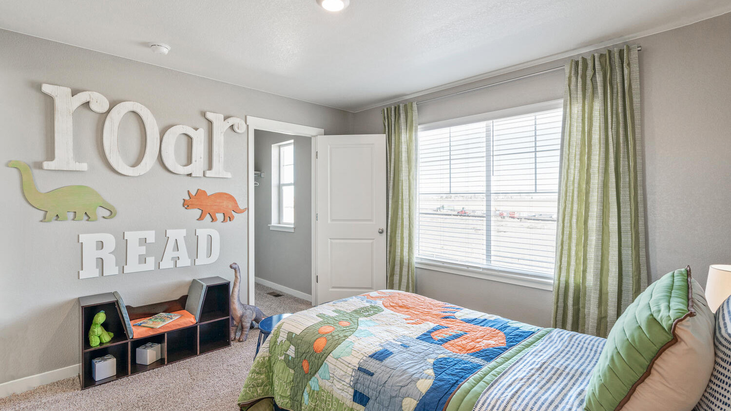 Secondary bedroom with large windows at new home community, Settler's Crossing
