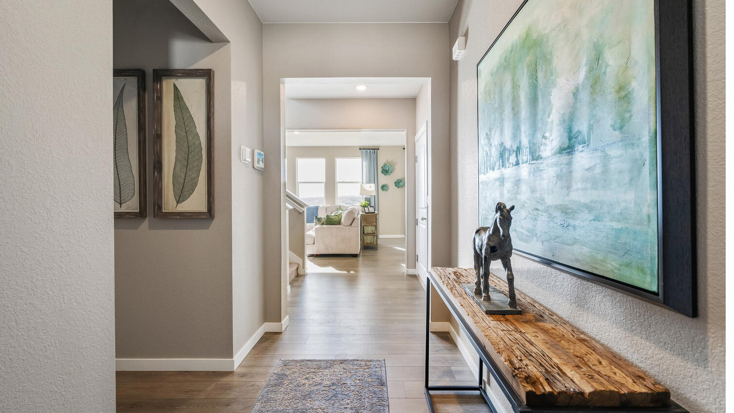 View from foyer showing opening to to first floor full bath, stairwell, and main living area