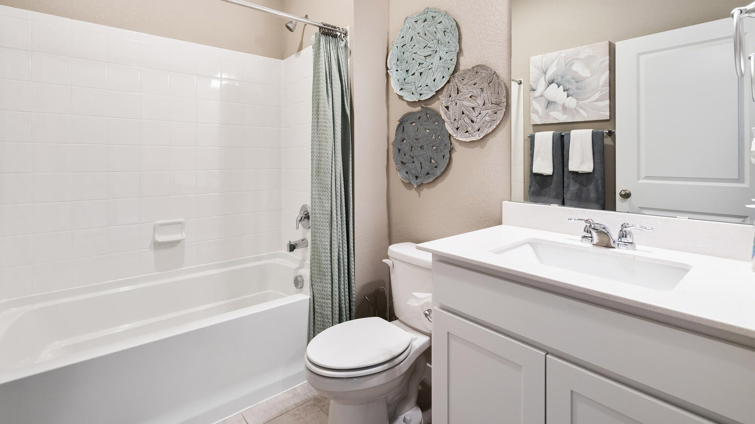 Full bath on main floor with shower/tub combo, large mirror, and chrome fixtures