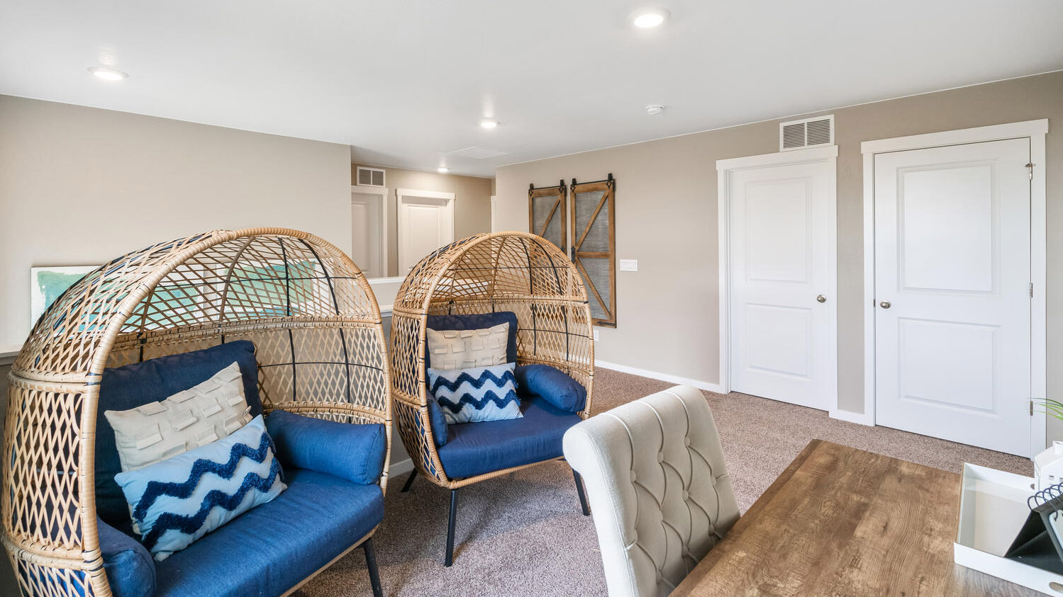 Alternate view of loft area showing doors to secondary bedroom and vacuum closet across from stairwell