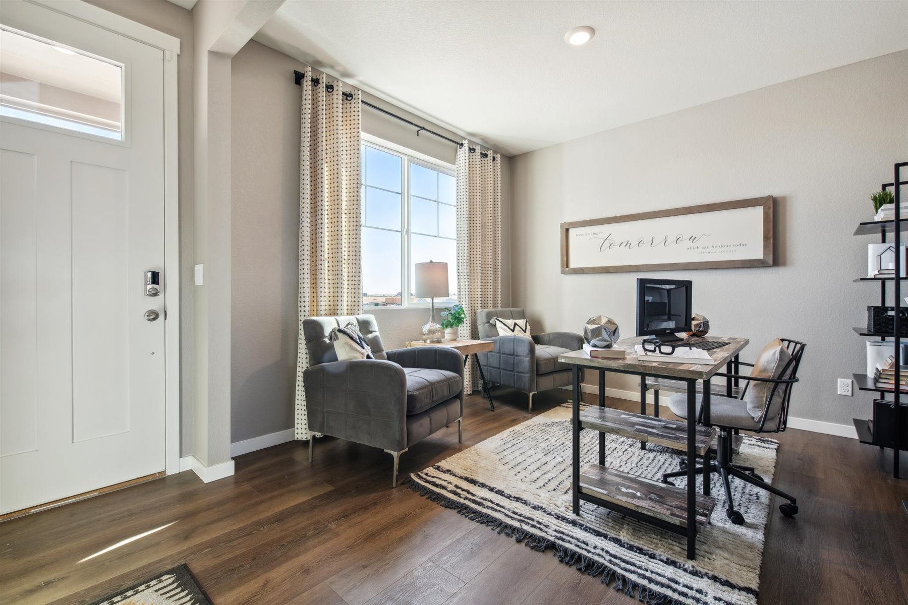 Entryway and open-concept layout on main floor with large window in study and 9’ ceiling