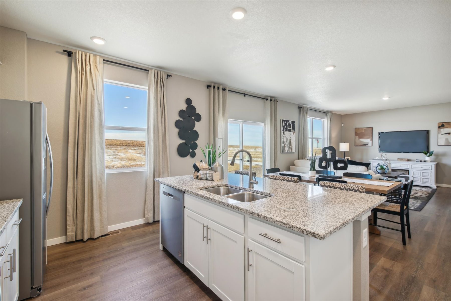 Back view of kitchen island showing built-in cabinetry and integrated dining and great room
