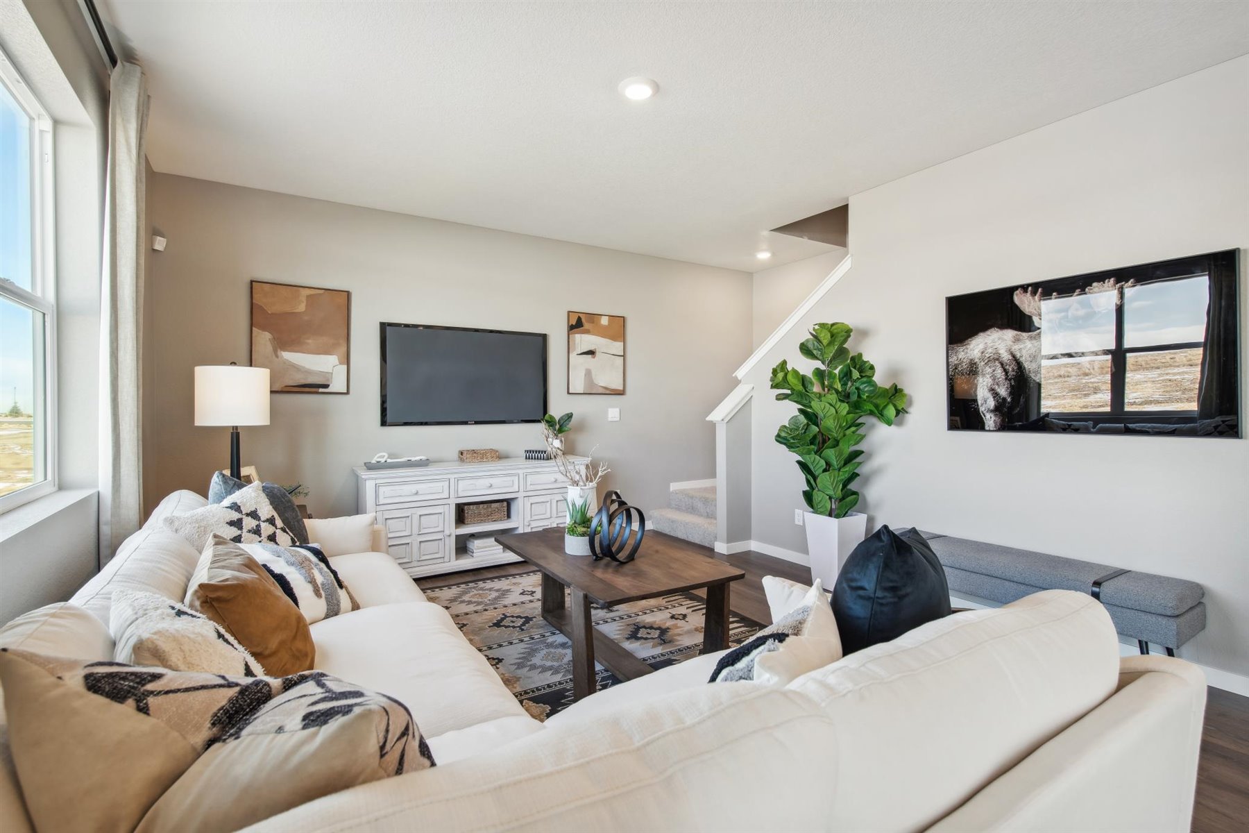 Great room with large window, LED lighting, 9' ceiling, and ascending staircase