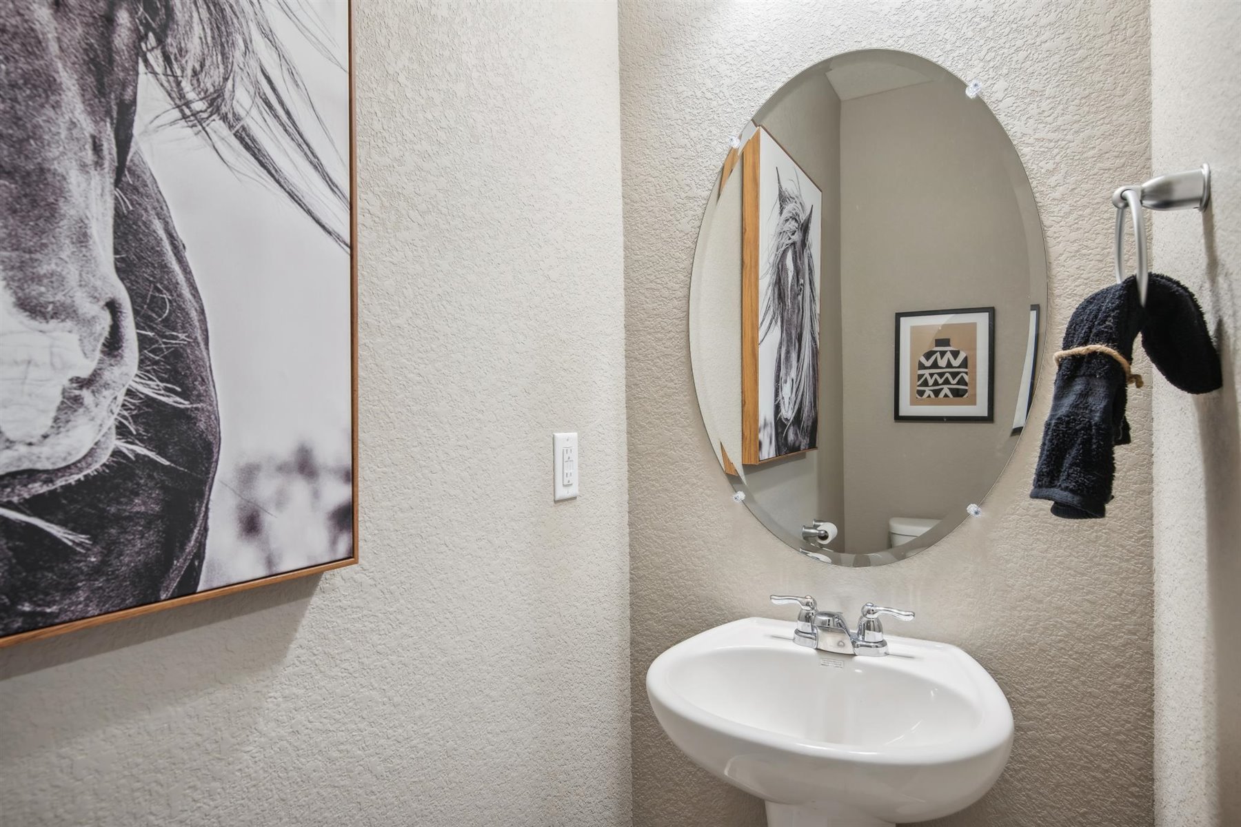 Powder room on lower level with pedestal sink
