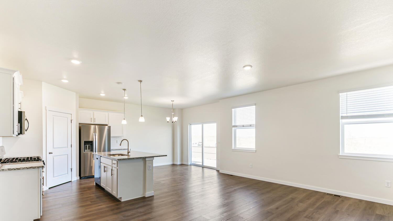 Open airy floor plan layout showing kitchen, dining area, and outdoor patio access