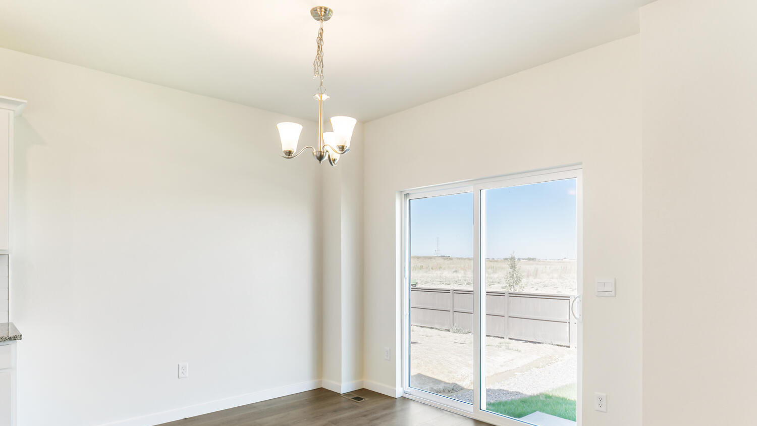 Dining nook with chandelier lighting and sliding patio door leading to outdoors