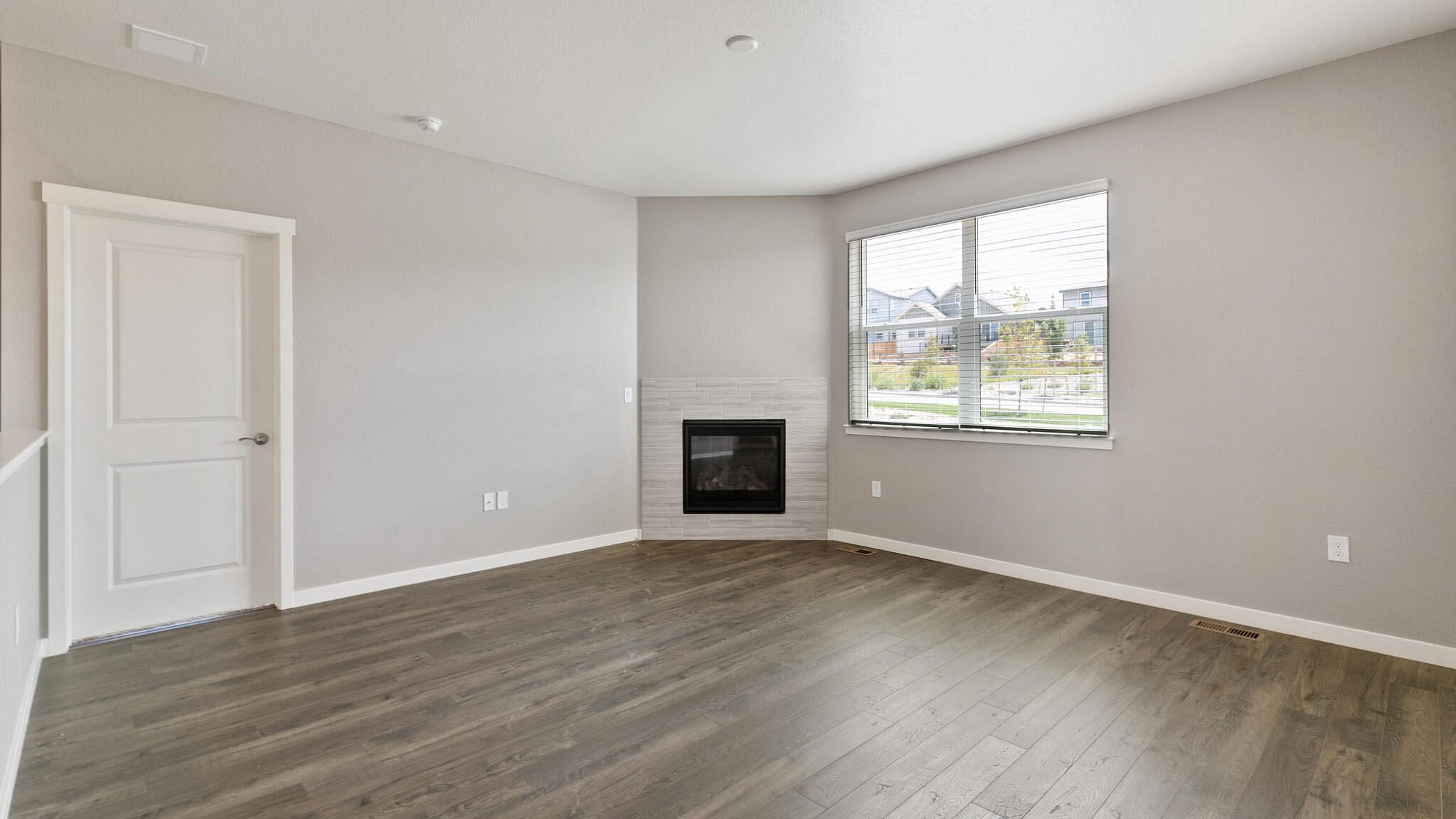 living room with fireplace in new construction home elizabeth, co