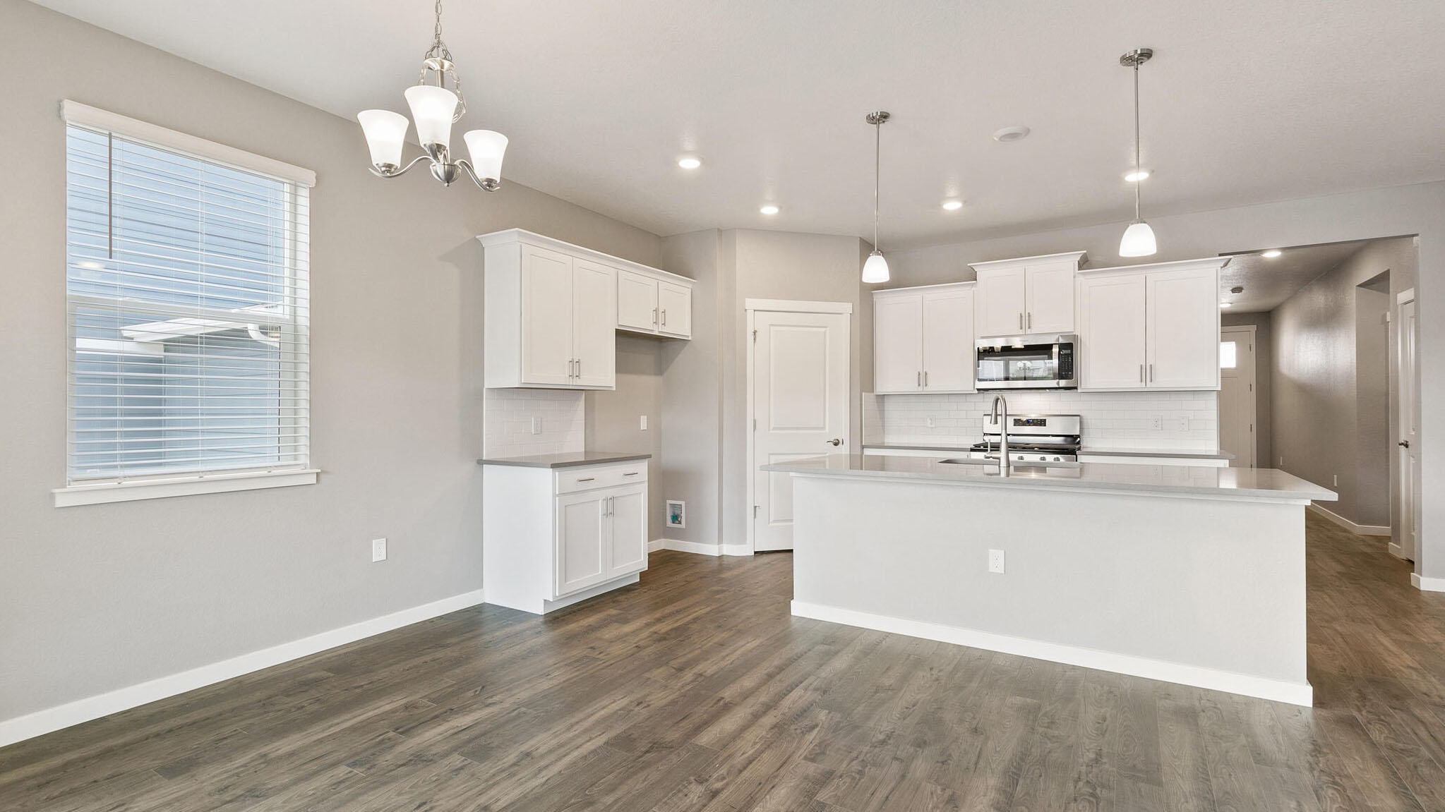 dining room and kitchen in new construction home by d.r. horton