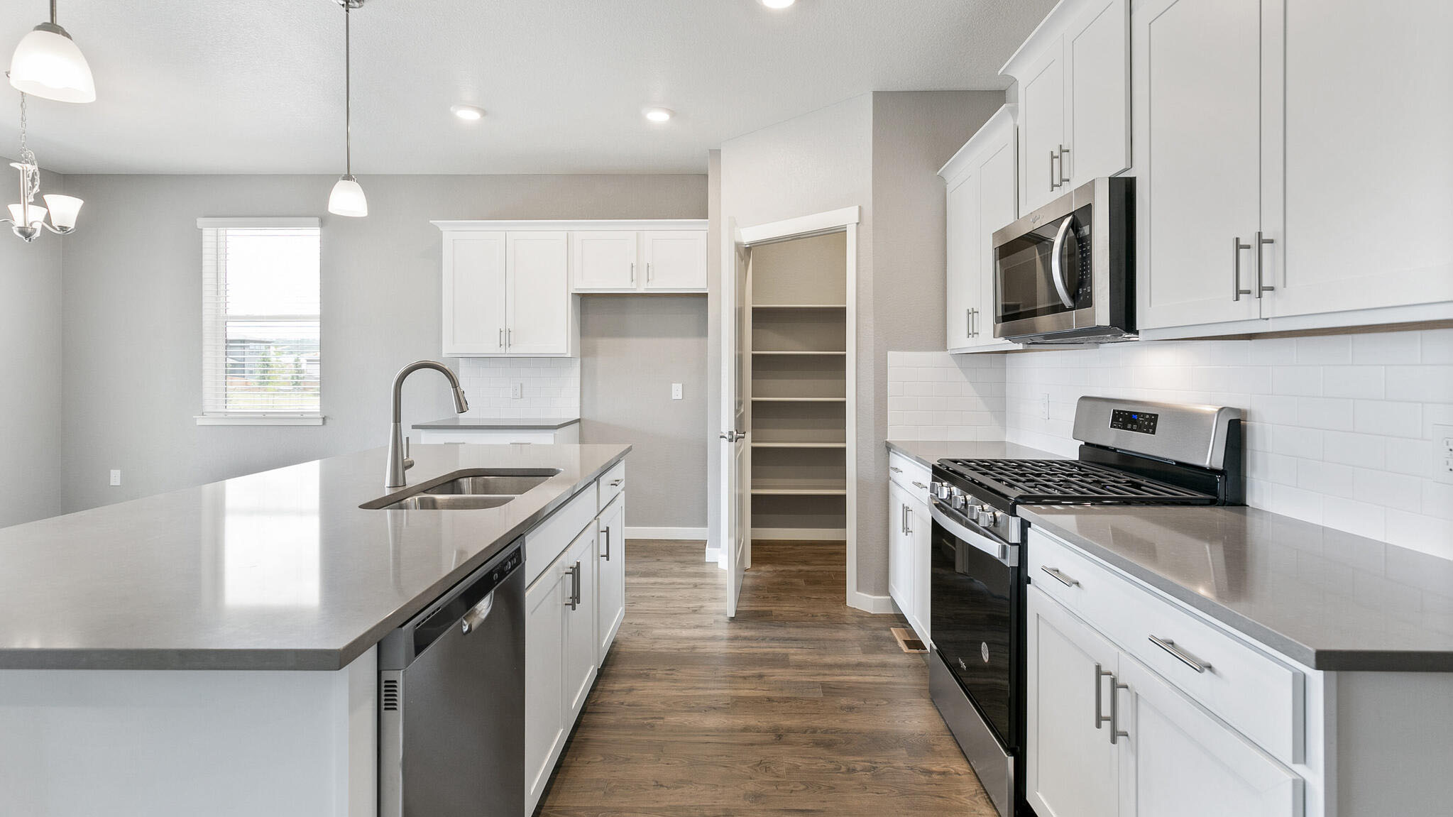 kitchen with stainless steel appliances in new construction home by d.r. horton