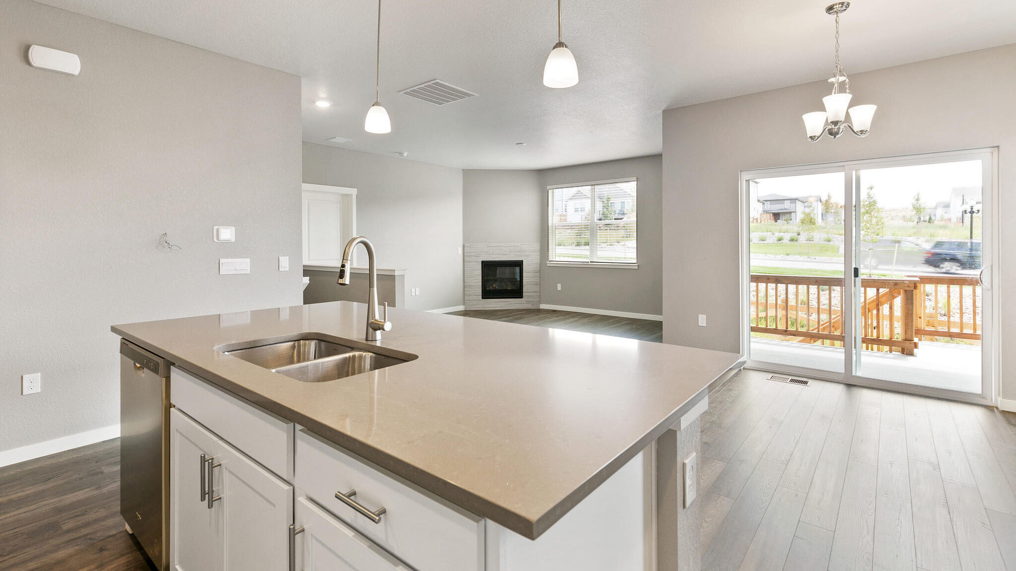 view from kitchen into dining and living room of new home elizabeth, co