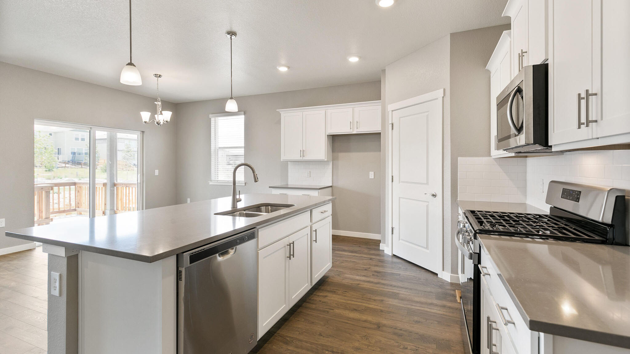 kitchen with brush nickel pendants in new construction home elizabeth, co