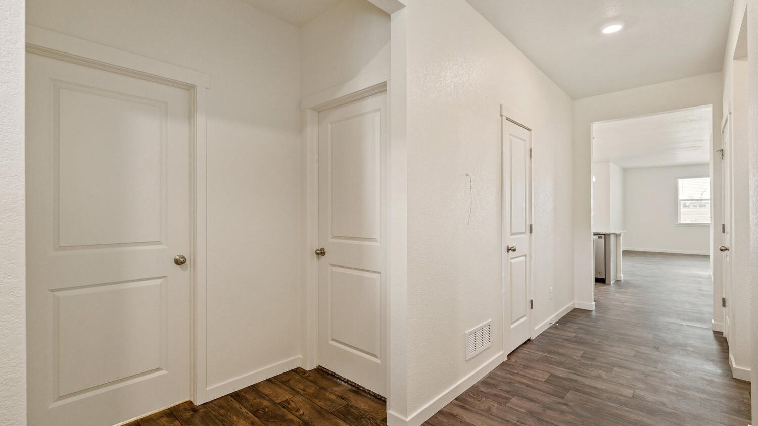 Foyer leading to two secondary bathrooms, a shared bath, and the main living area