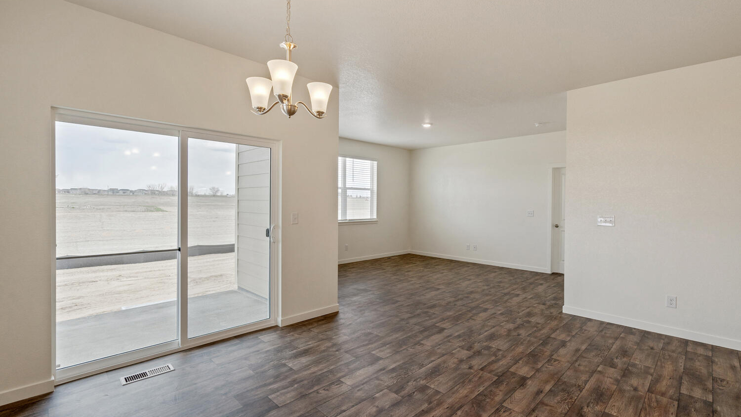 Covered patio near dining area through sliding doors and corner of great room