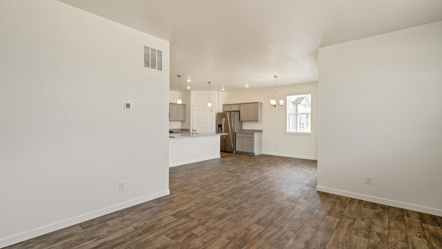 View from great room into kitchen and corner pantry