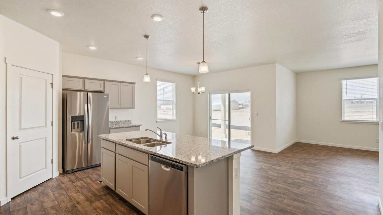 Kitchen pantry and center island with built-in sink and cabinets