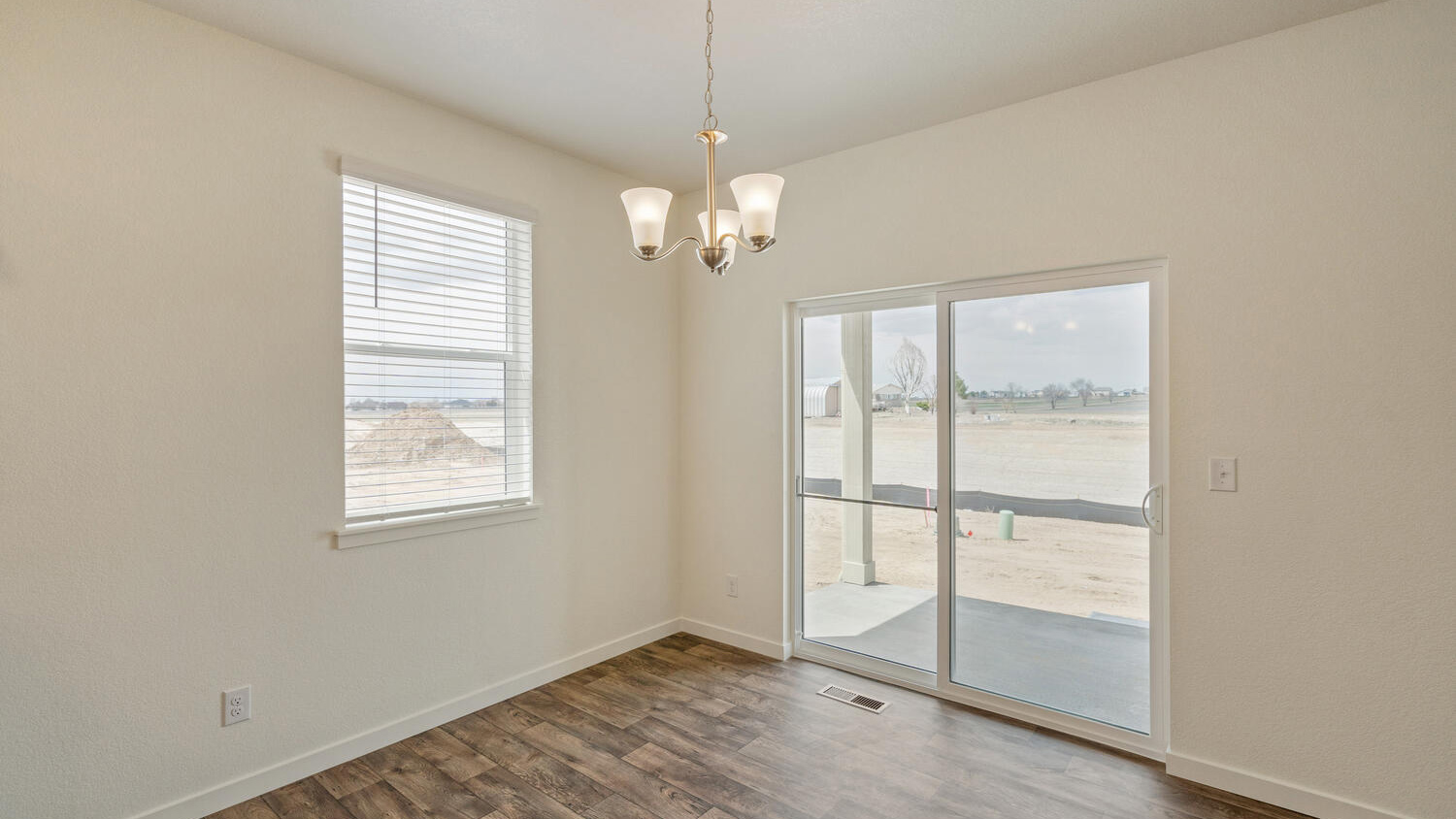 Dining area with suspended lighting and view of outdoor covered patio