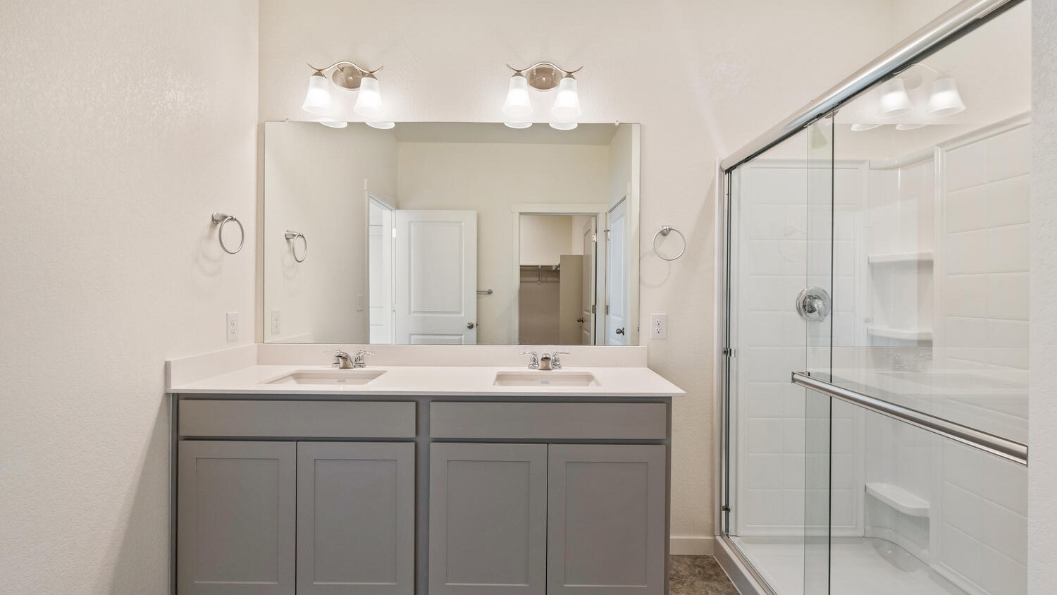 Raised height vanity, double sinks, and step-in shower