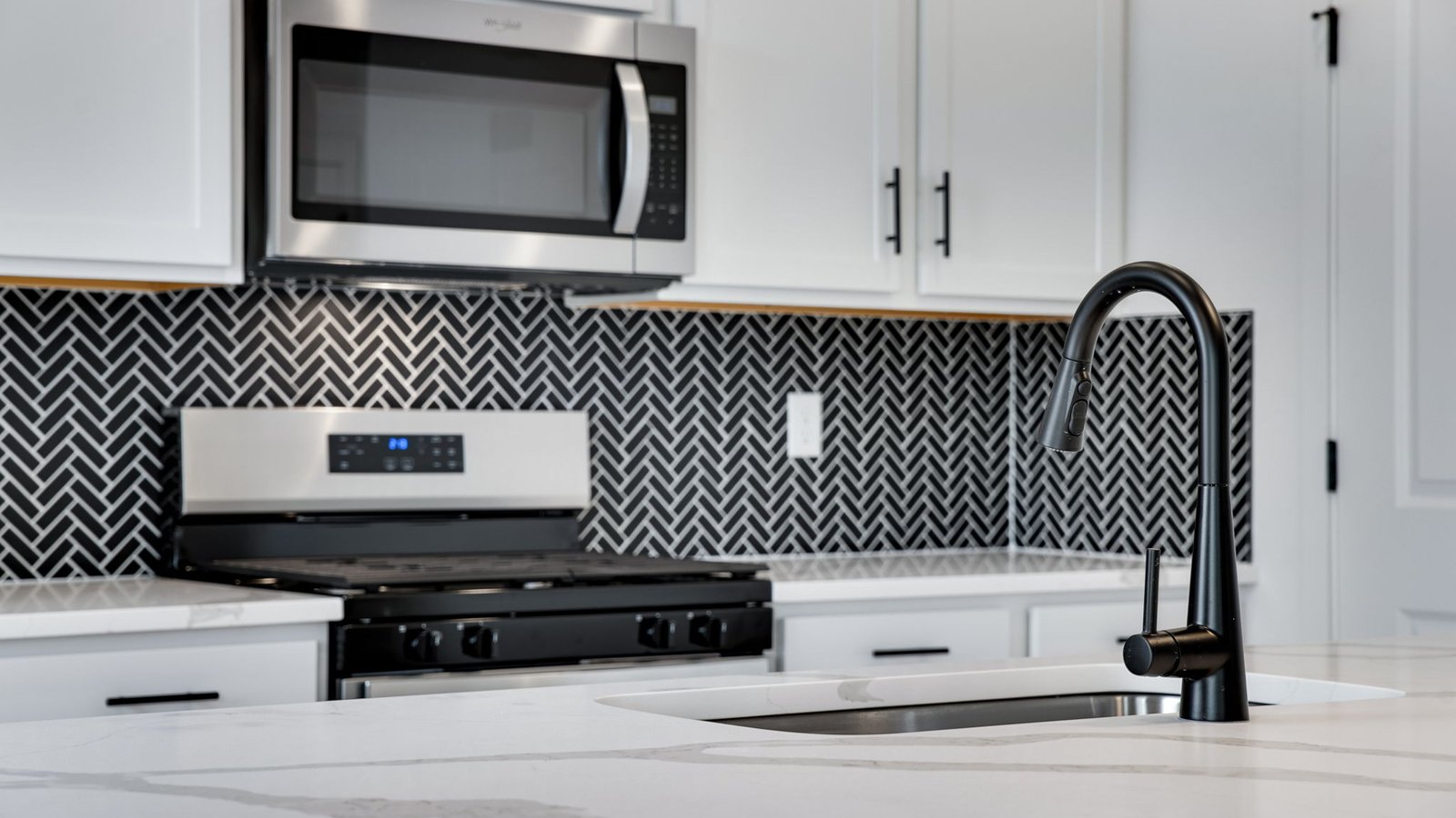 modern black backsplash in new construction home by d.r. horton
