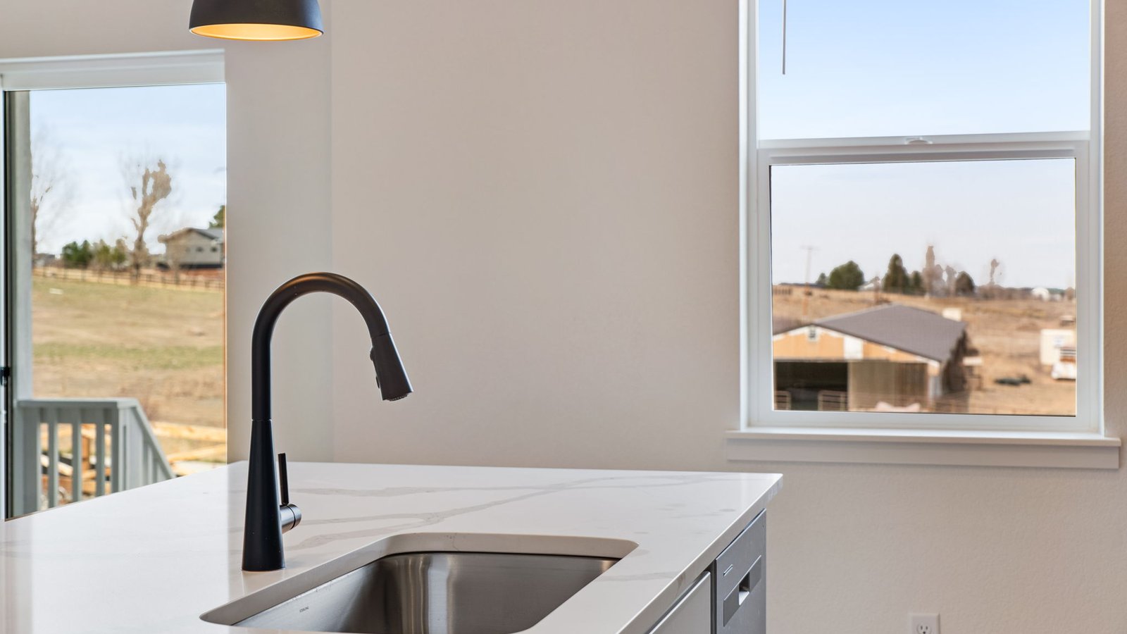 island sink with black faucet in new construction home by d.r. horton