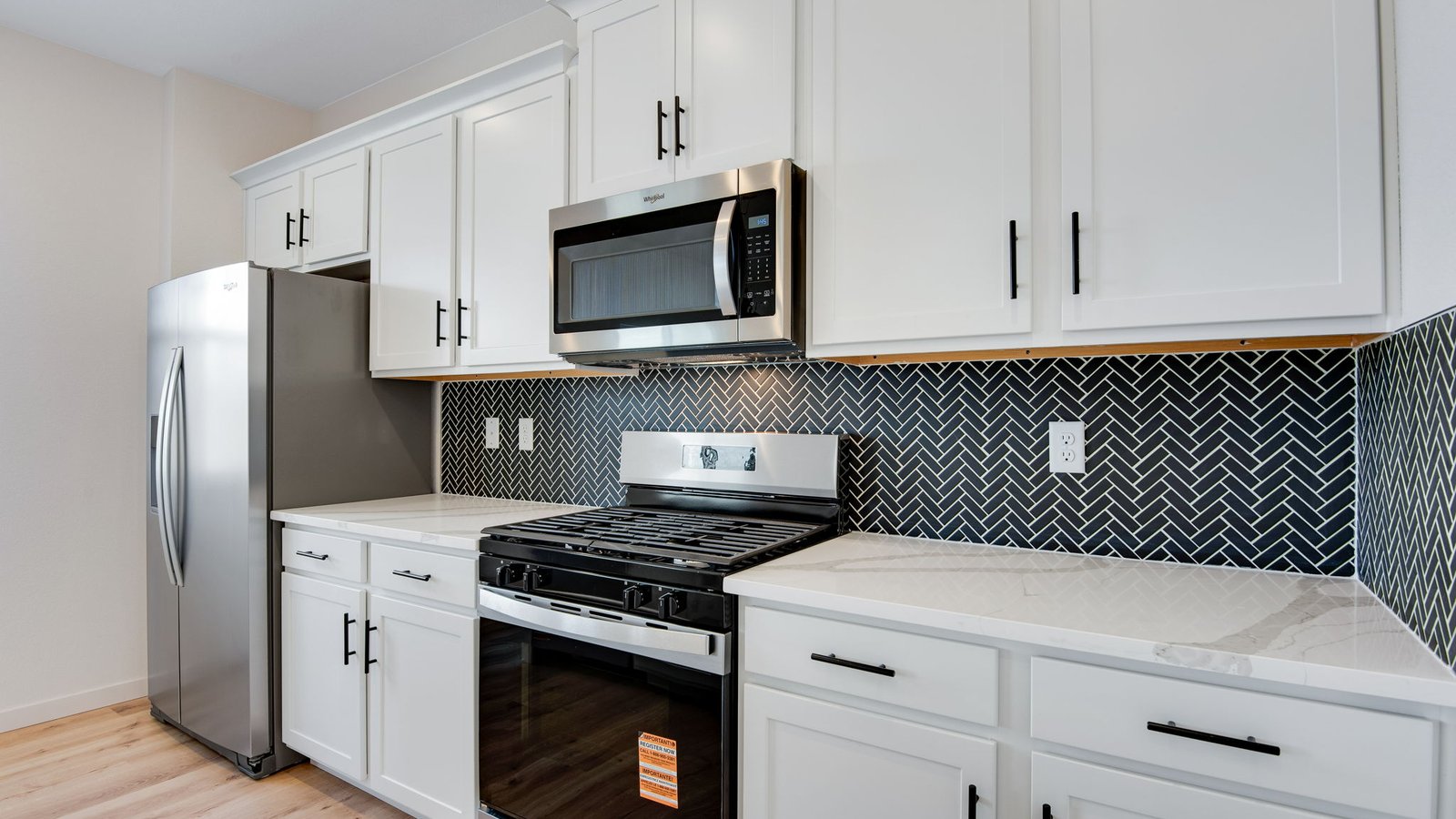 white cabinets and stainless steel appliances in new home elizabeth, co