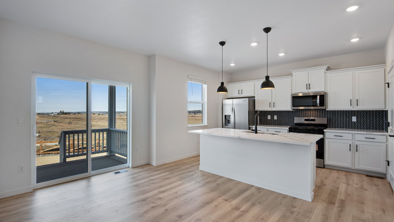 Spacious Kitchen with large windows in new home at Spring Valley Ranch Community