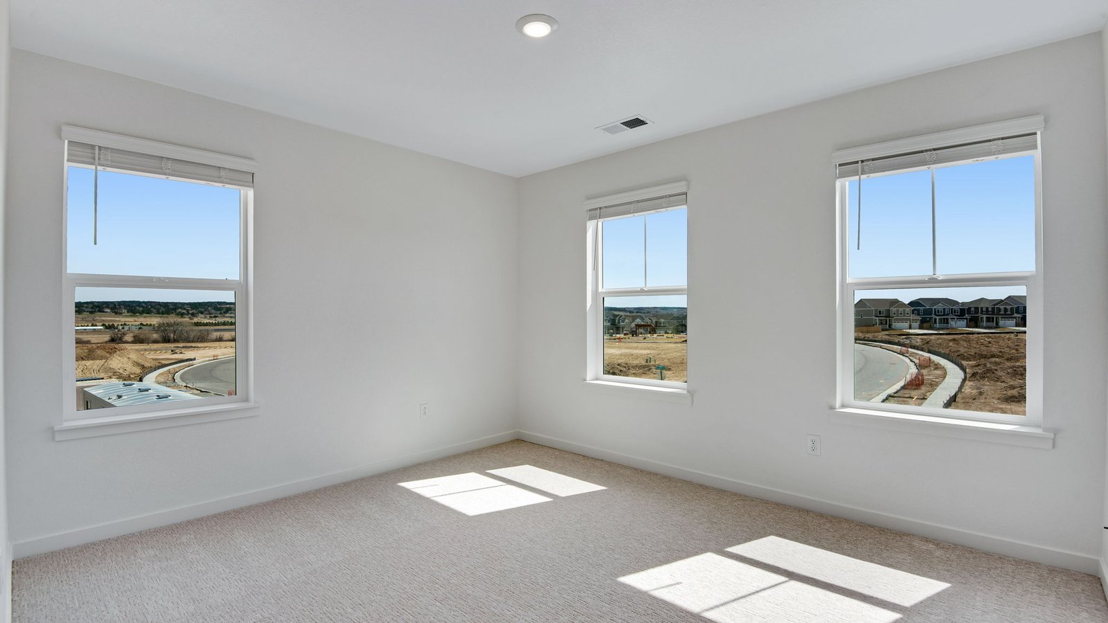 Secondary bedroom with large windows in new home near Parker Colorado
