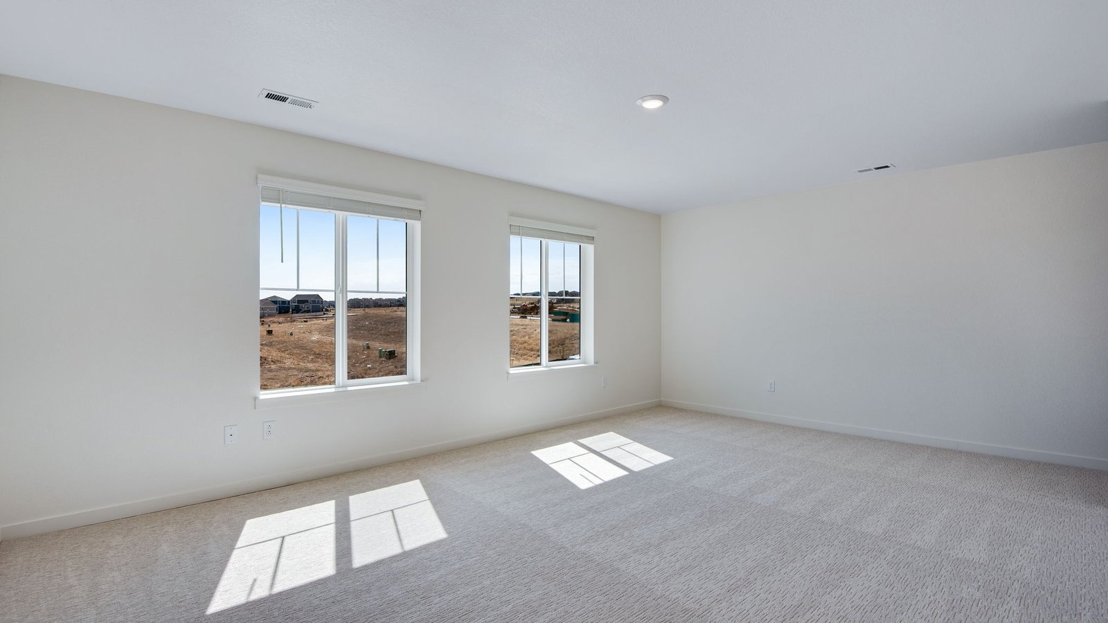 Primary bedroom with large windows in new D.R. Horton home in Elizabeth, Colorado