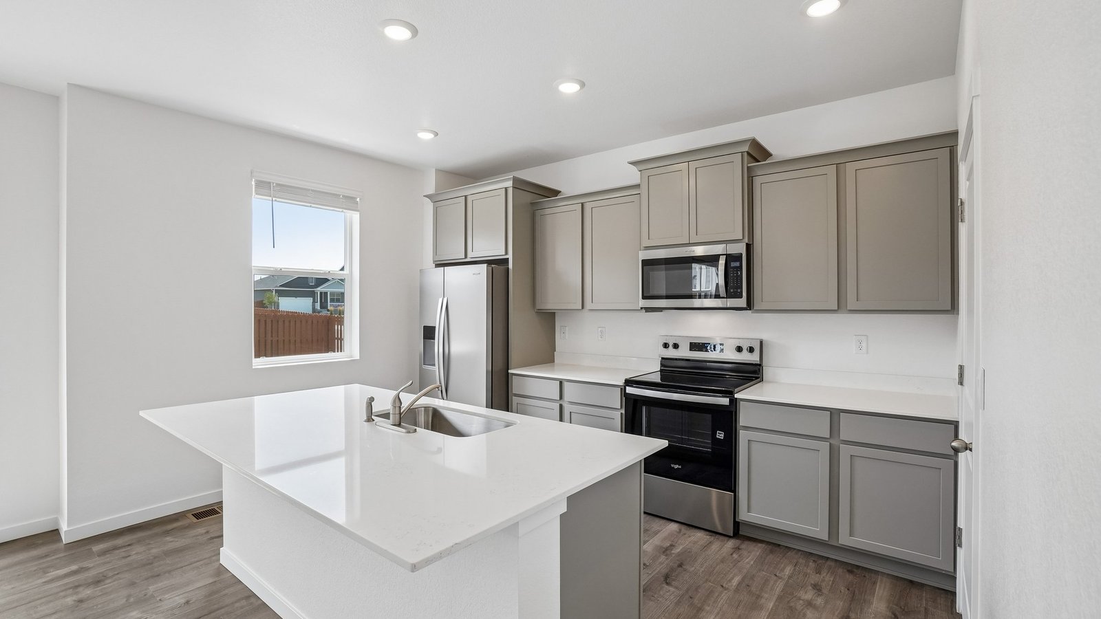 Spacious kitchen with chelsea grey finishes in new home at Spring Valley Ranch Community