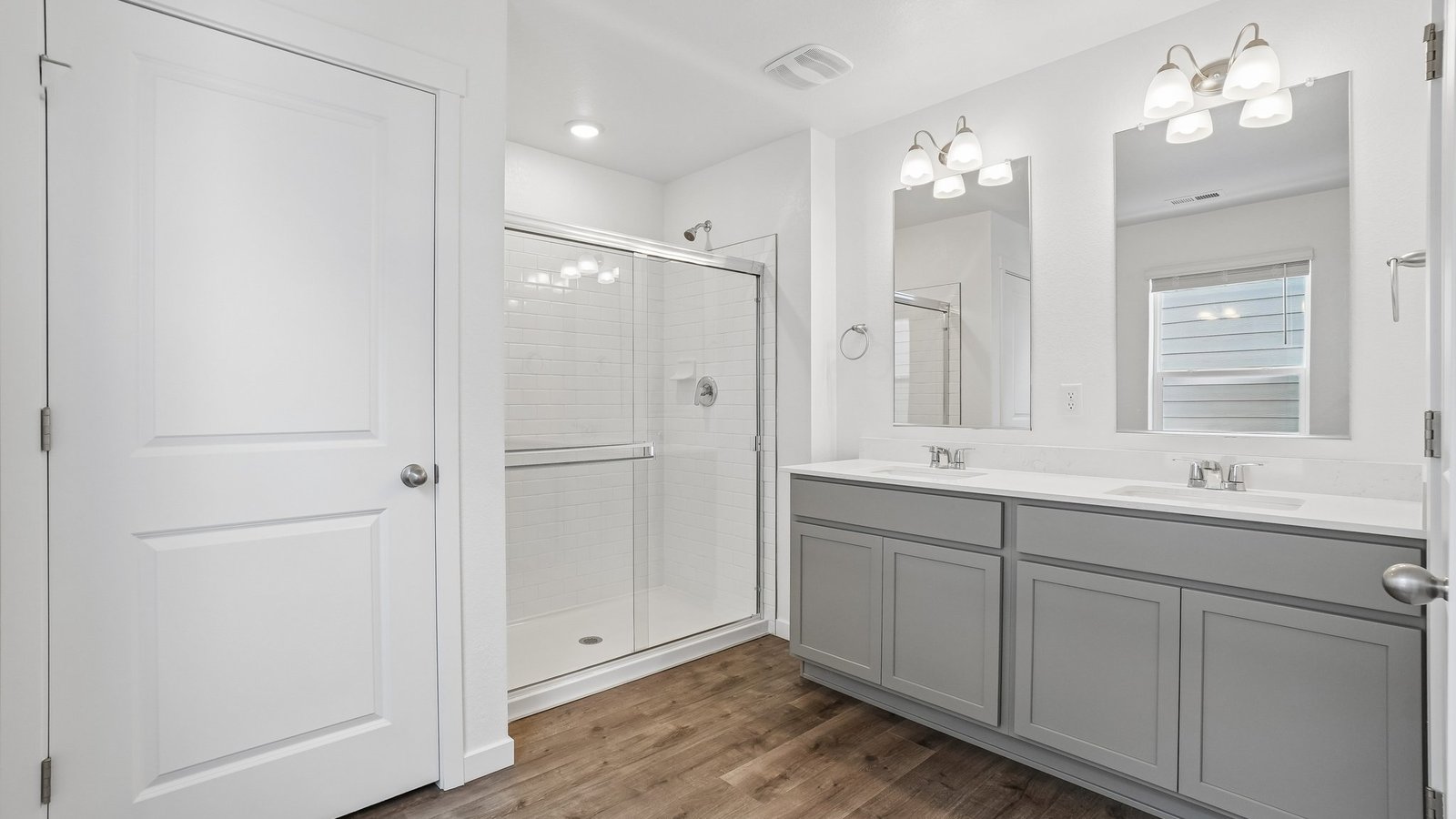 Private attached primary bathroom with dual vanity sinks at new home community near parker, colorado