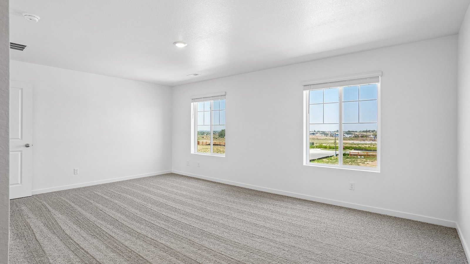 Spacious primary bedroom with large windows in Elizabeth Colorado