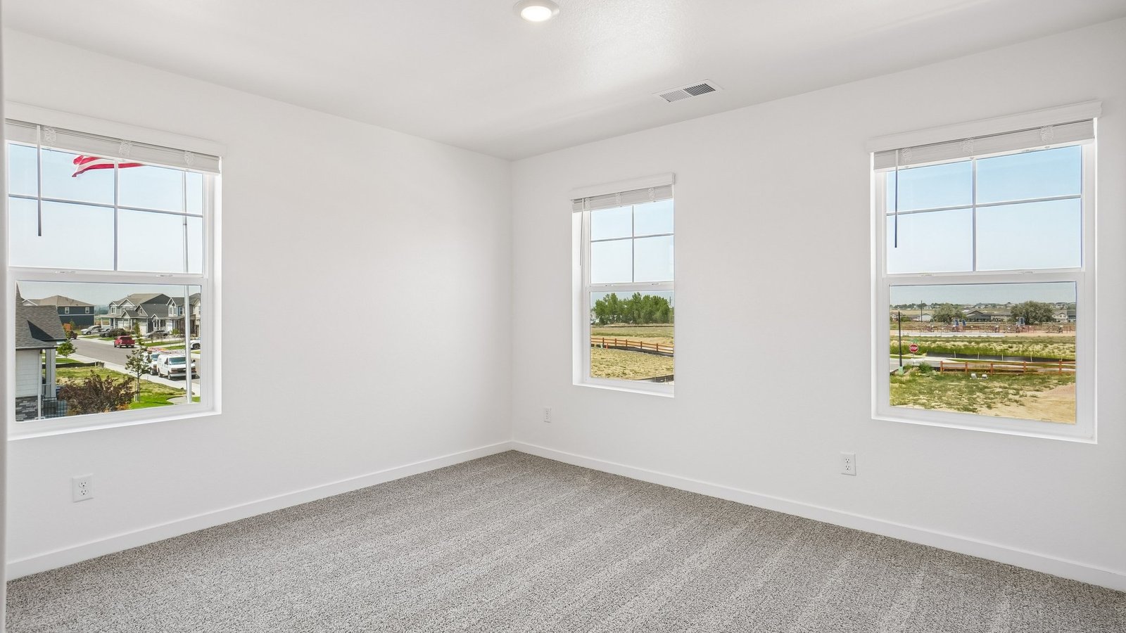Secondary bedroom with large windows in new D.R. Horton community near Spring Valley Ranch