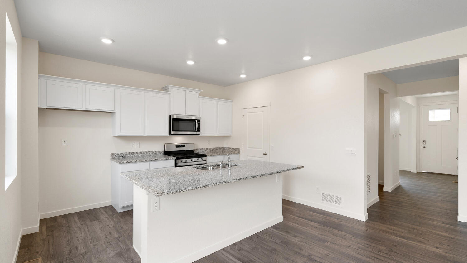 Kitchen including center island, granite countertops, premium cabinetry, a pantry, and LED lighting