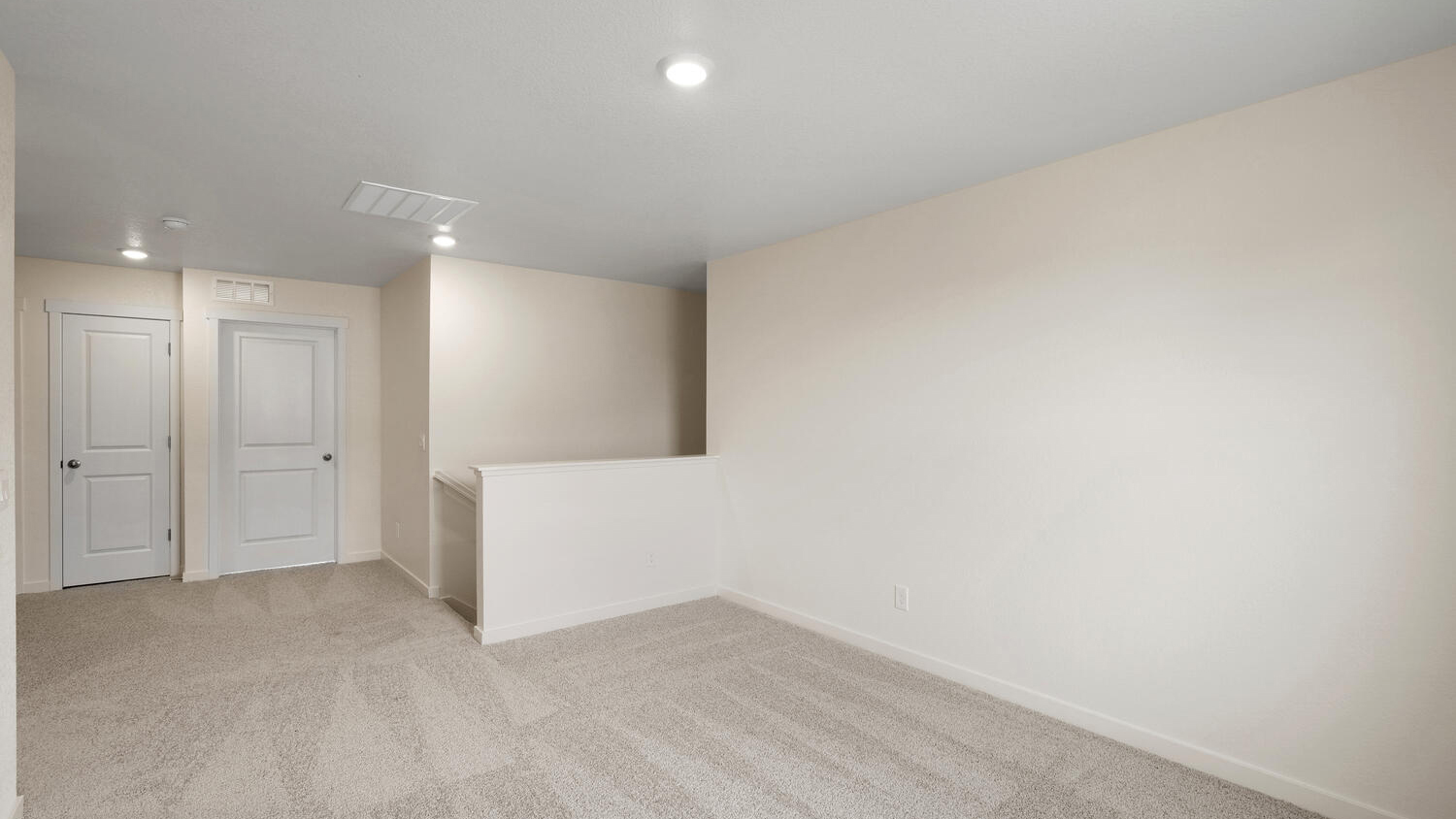 View of loft at top of stairwell with plush carpeting