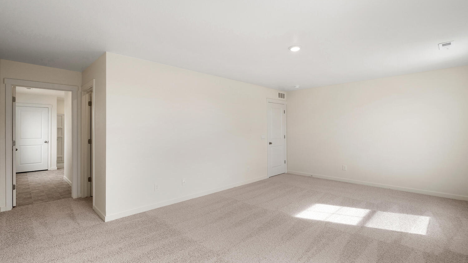 Alternate view of primary bedroom showing walk-in closet door