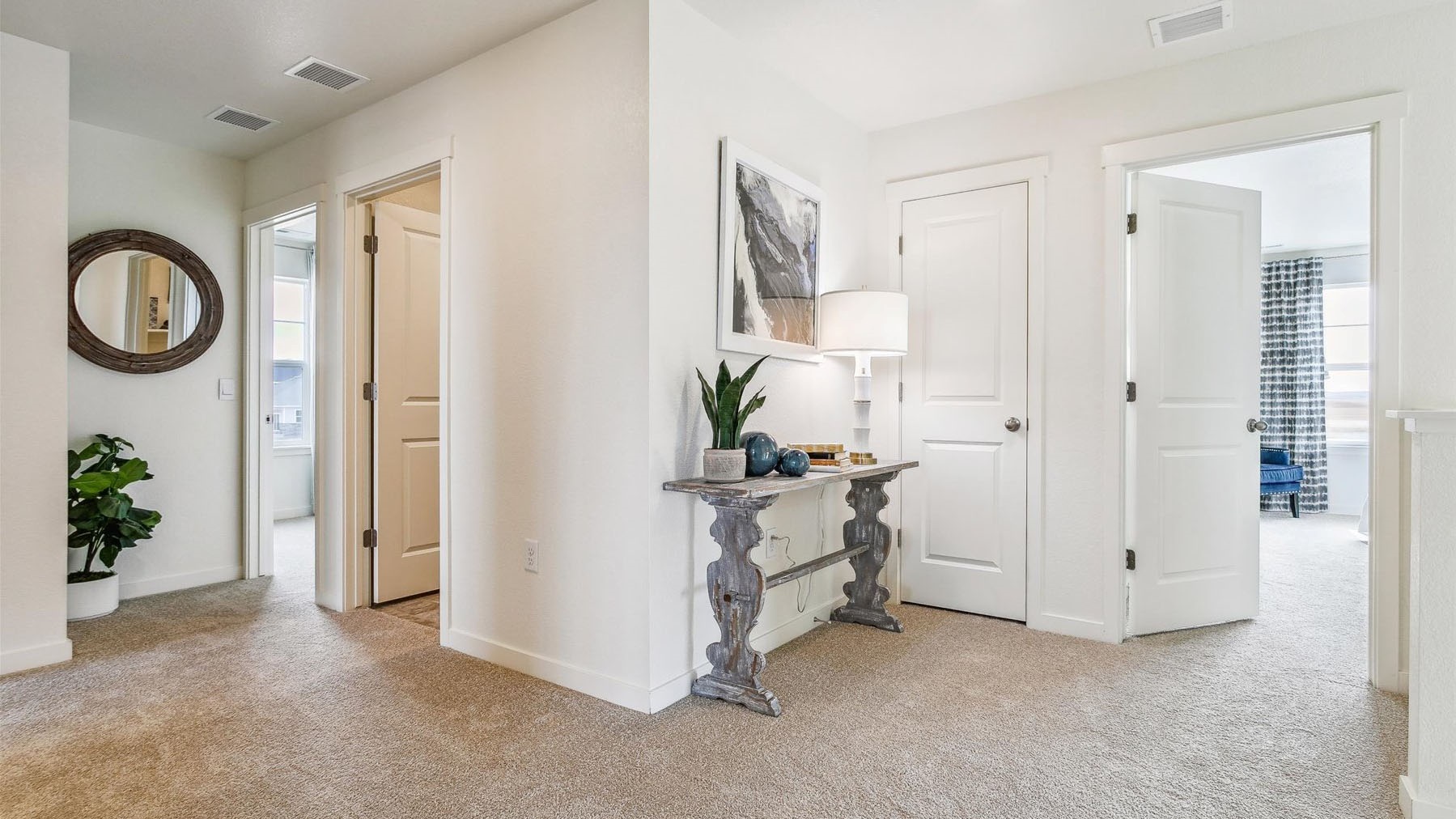 Upper floor hallway showing primary bedroom, linen closet, laundry room, and secondary bedroom