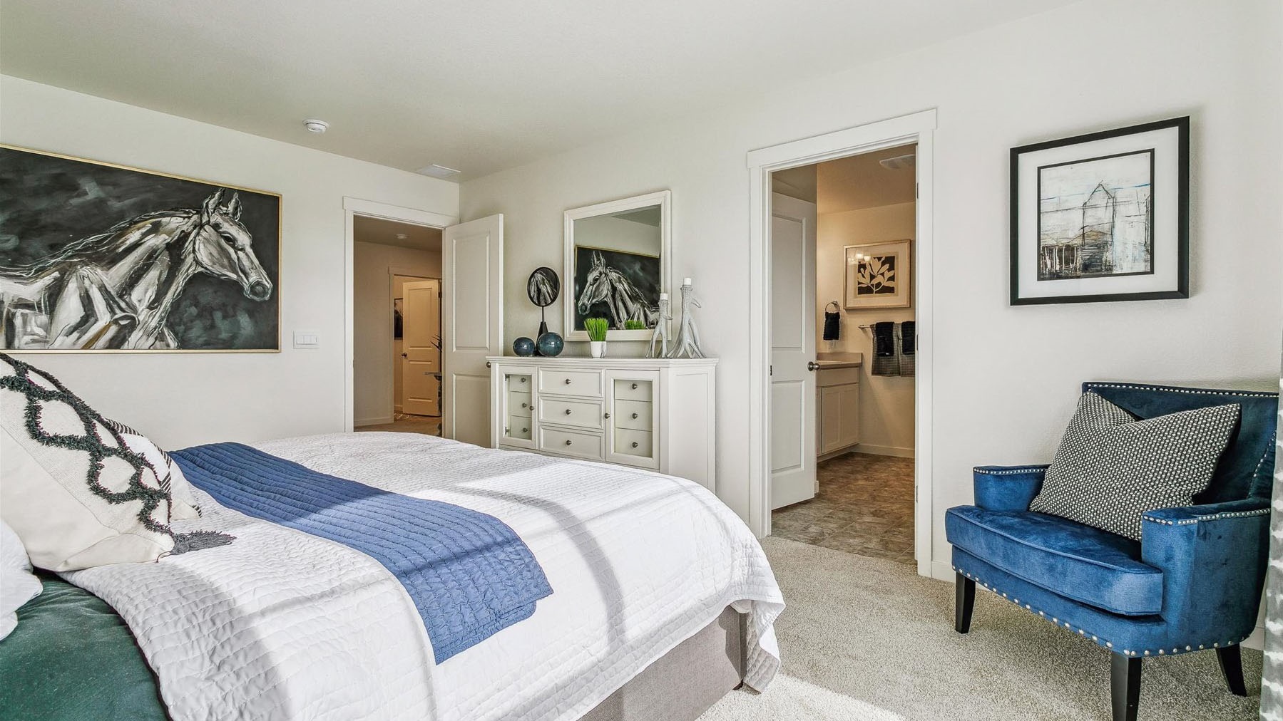 Alternate view of primary bedroom showing private bathroom