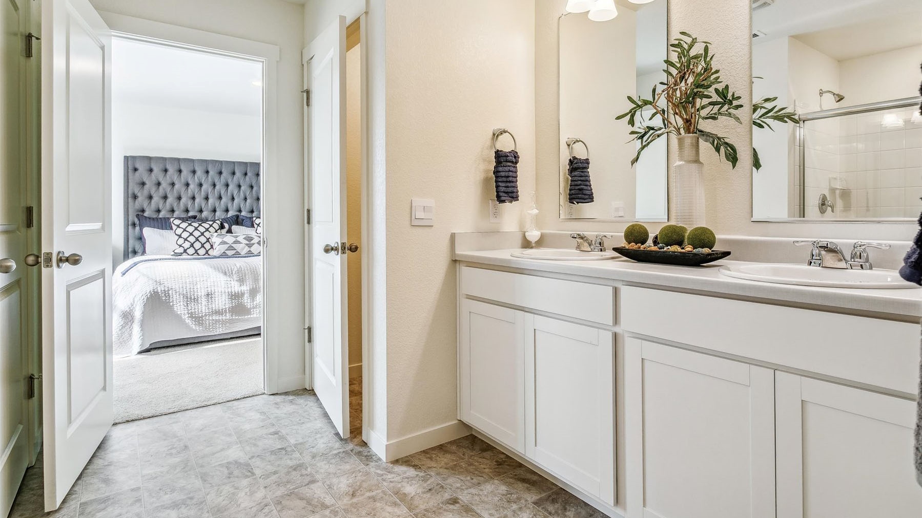 Private bath with water closet, ample cabinet storage and counterspace, and chrome finishes
